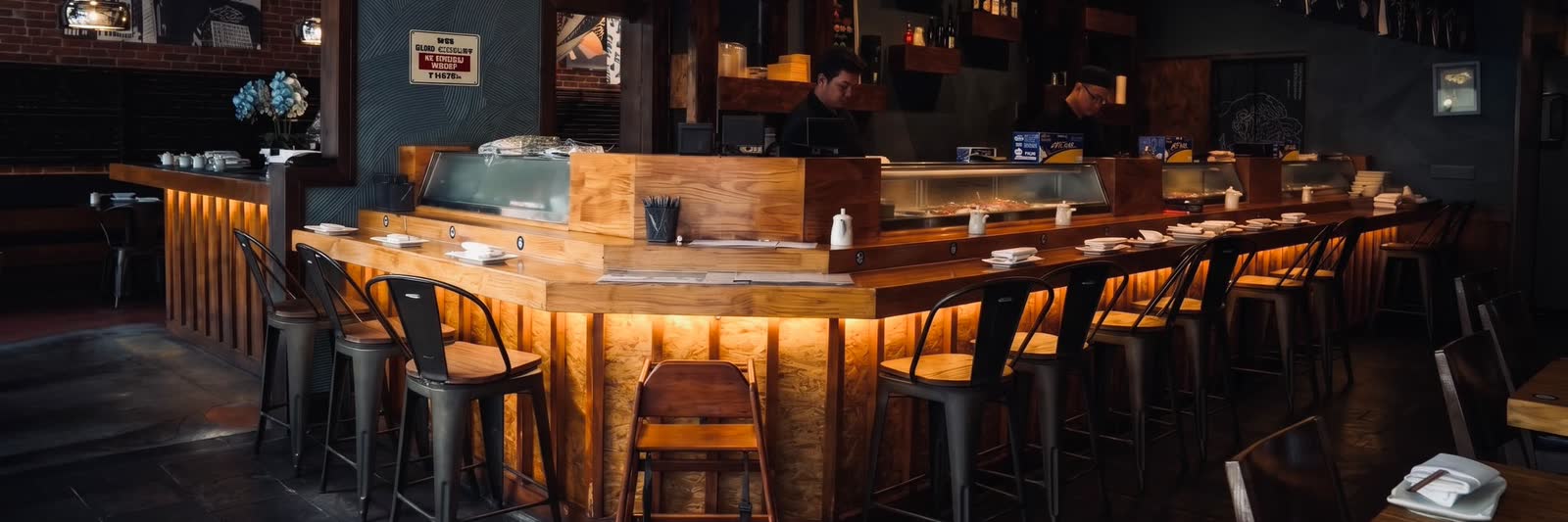 The open sushi counter at Blue Fish in Montrose, chefs at work behind the case